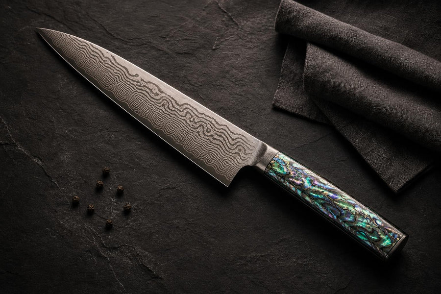 Murasaki — Damascus Chef Knife with Abalone Shell Handle flat lay photo