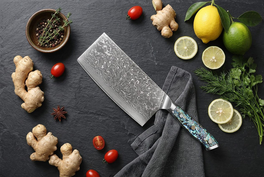 Kaigan — VG10 Damascus Cleaver with Abalone Handle flat lay photo