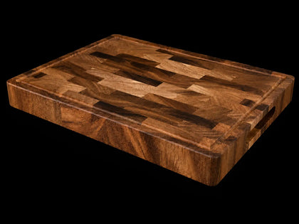 Acacia wood cutting board with end-grain pattern on a black background