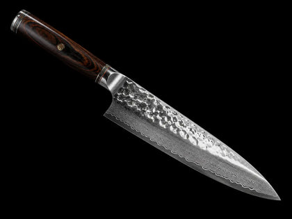 Japanese Damascus chef knife with hammered steel blade and dark wooden handle