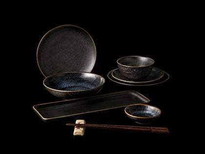 Black Japanese tableware set with ceramic plates, bowls, tray and wooden chopsticks